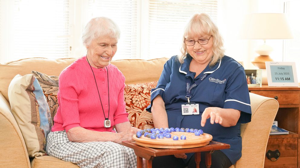 Carer playing board game with client