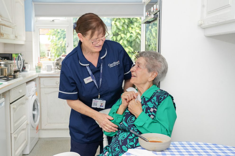 Carer assisting client with meal time