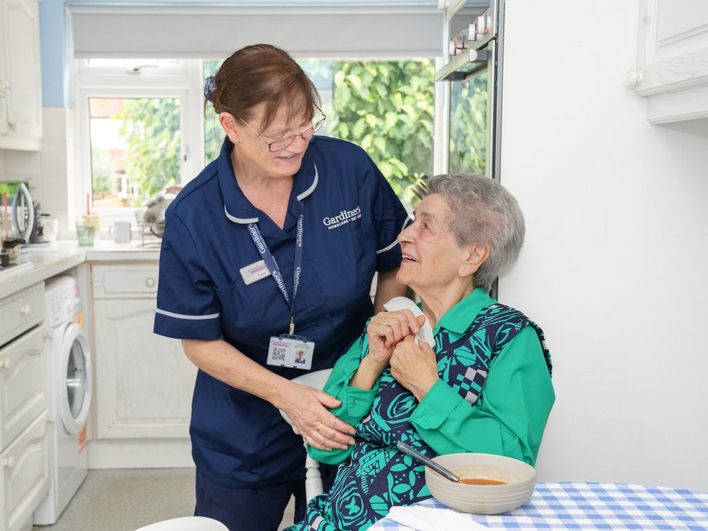 Carer assisting client with meal time