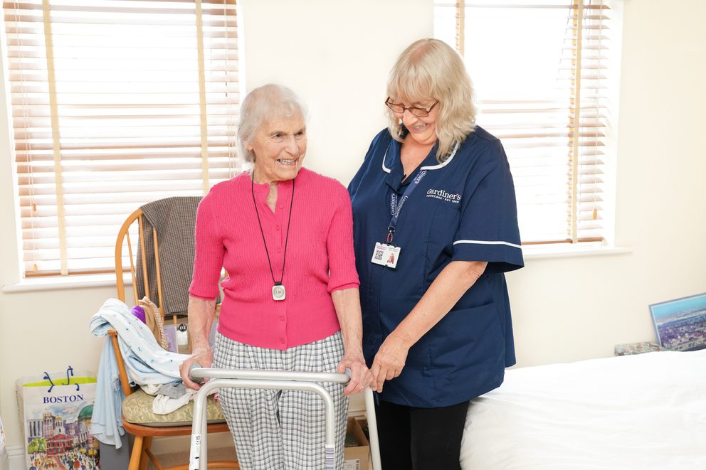 Carer assisting client with walker